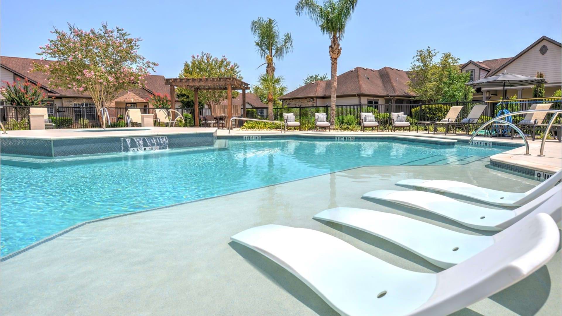 Resort-style pool with sun deck and heated spa